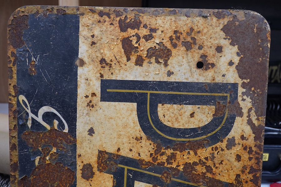 Two French advertising signs; a painted wood sign, width 157cm, and a painted steel sign, width 125cm. Condition - poor, general surface rust and paint loss.